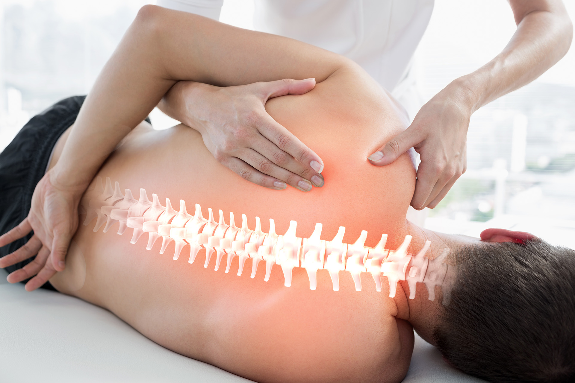 picture of osteopath in action on a patients spine